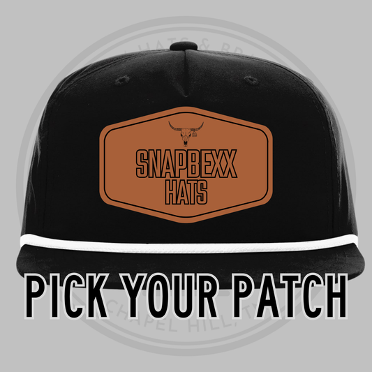 Black baseball cap with white underside brim, front patch reading SNAPDEXX HATS