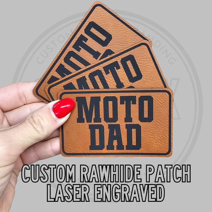 Tan leatherette patch with 'MOTO DAD' text and 'custom rawhide' style badge border