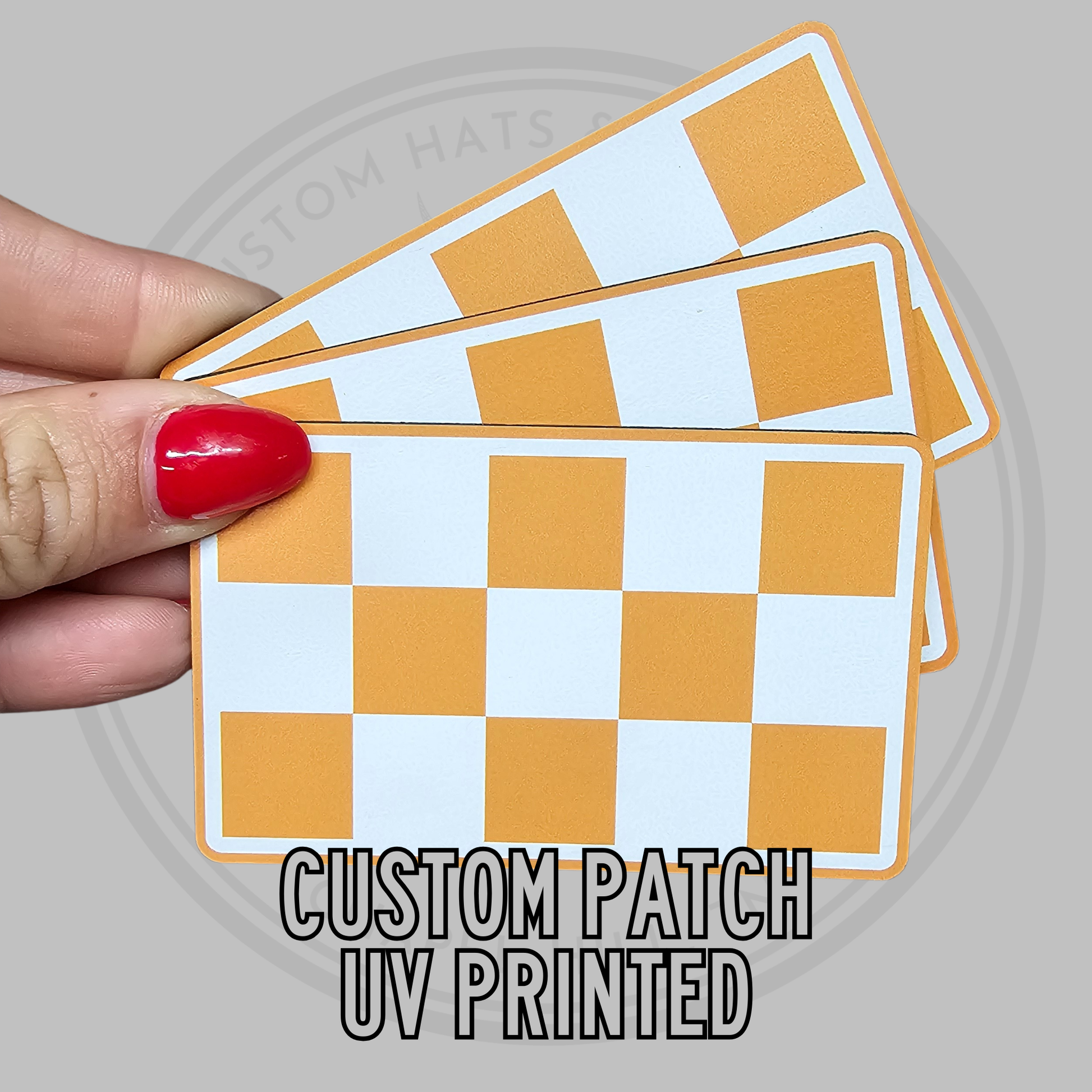 Checkered UV printed patch with white and tan squares, rectangular, stitched border