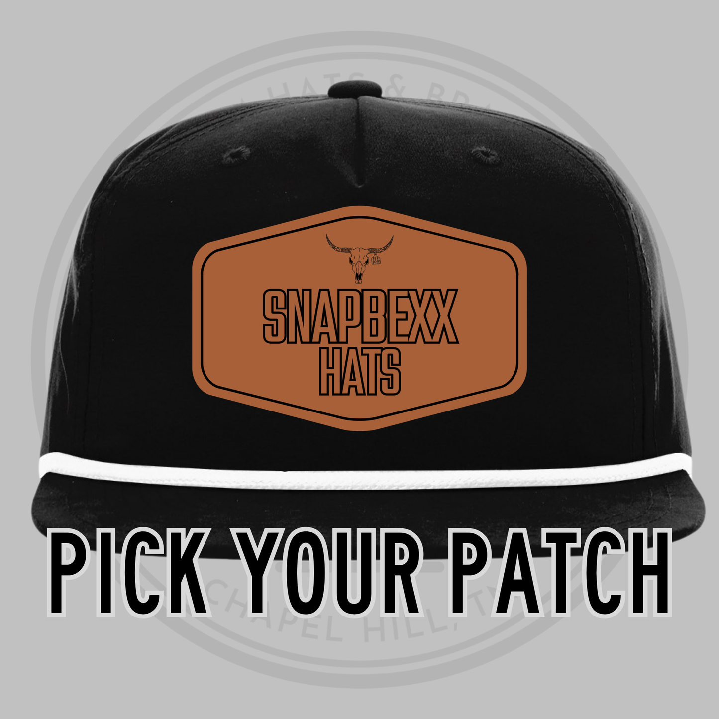 Black baseball cap with white underside brim, front patch reading SNAPDEXX HATS