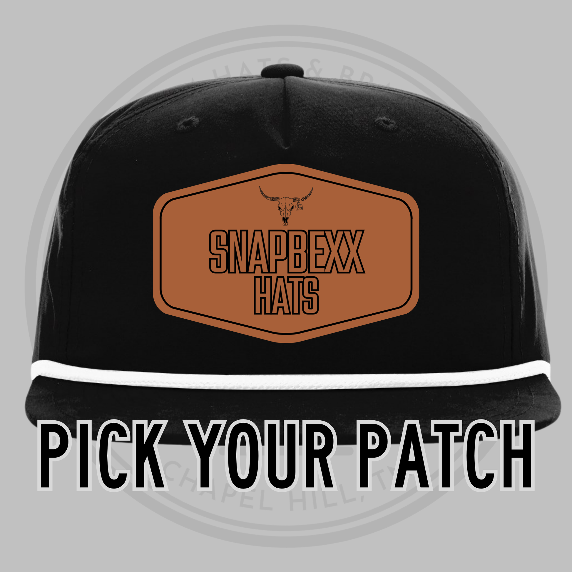 Black baseball cap with white underside brim, front patch reading SNAPDEXX HATS
