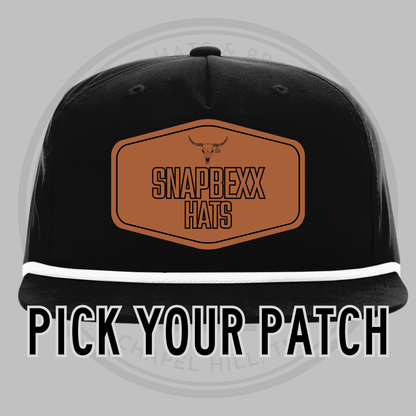 Black baseball cap with white underside brim, front patch reading SNAPDEXX HATS