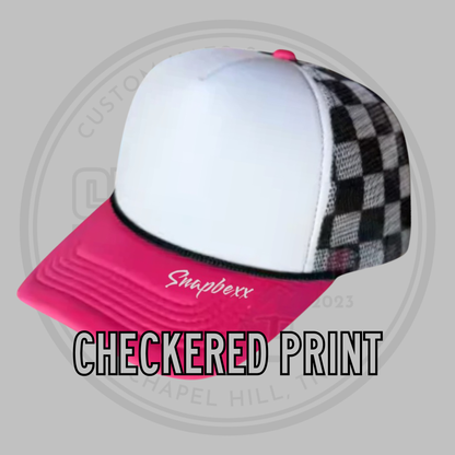 Foam trucker cap with white front, black-and-white checkered sides, pink visor