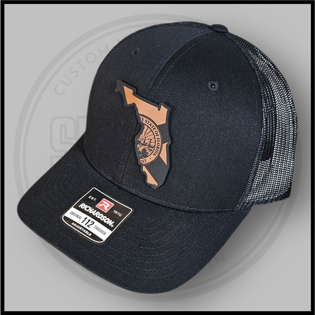 Black Richardson trucker cap with Florida outline and state seal patch, adjustable back