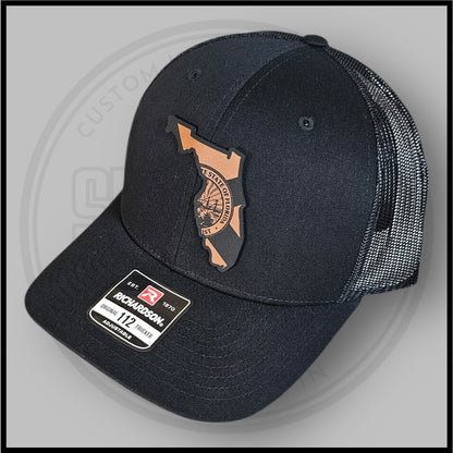 Black Richardson trucker cap with Florida outline and state seal patch, adjustable back