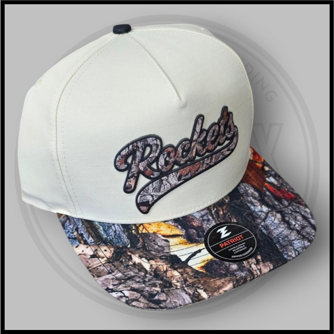 Cream baseball cap angled view with Rockets logo and Patriot patch on camo brim