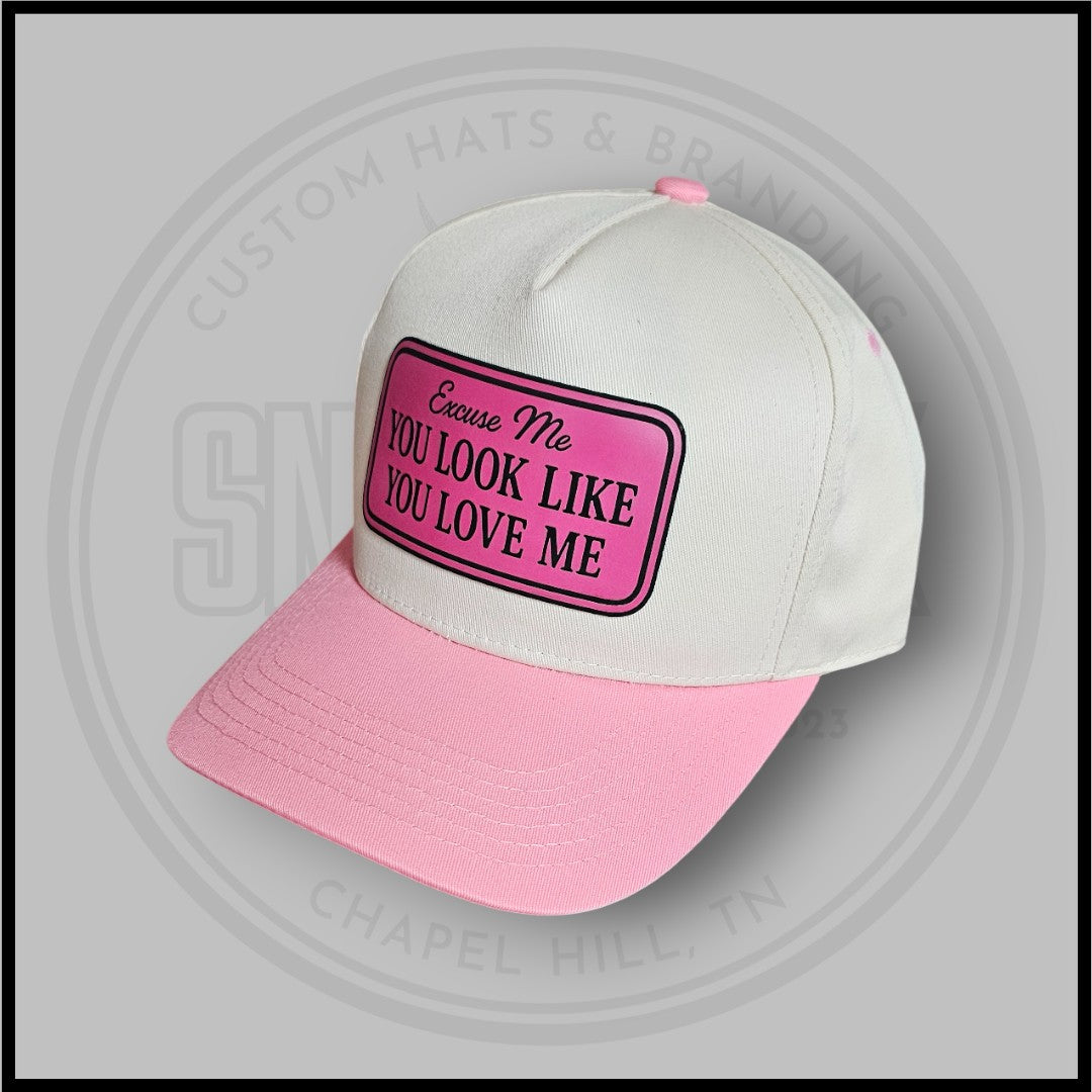 White and pink trucker cap with 'You Look Like You Love Me' front patch
