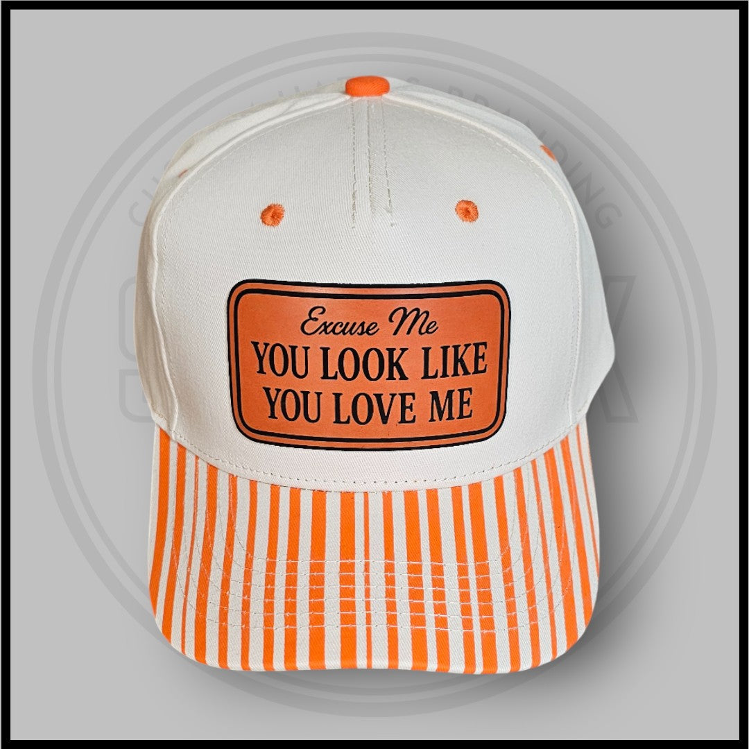 Orange striped baseball cap with white crown and embroidered slogan patch