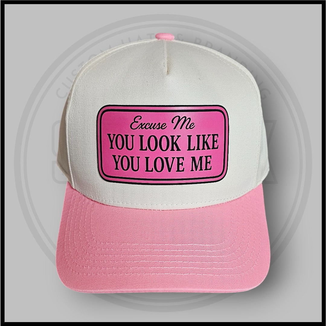 Pink-and-white trucker cap with large front patch and curved brim
