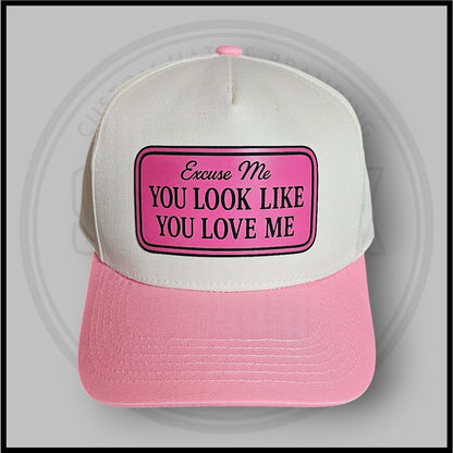 Pink-and-white trucker cap with large front patch and curved brim