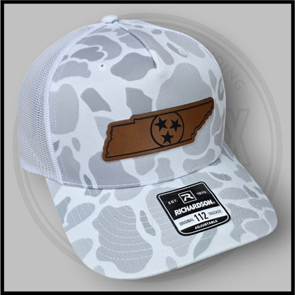 Duck camo trucker cap with brown logo patch, Richardson tag, adjustable mesh back