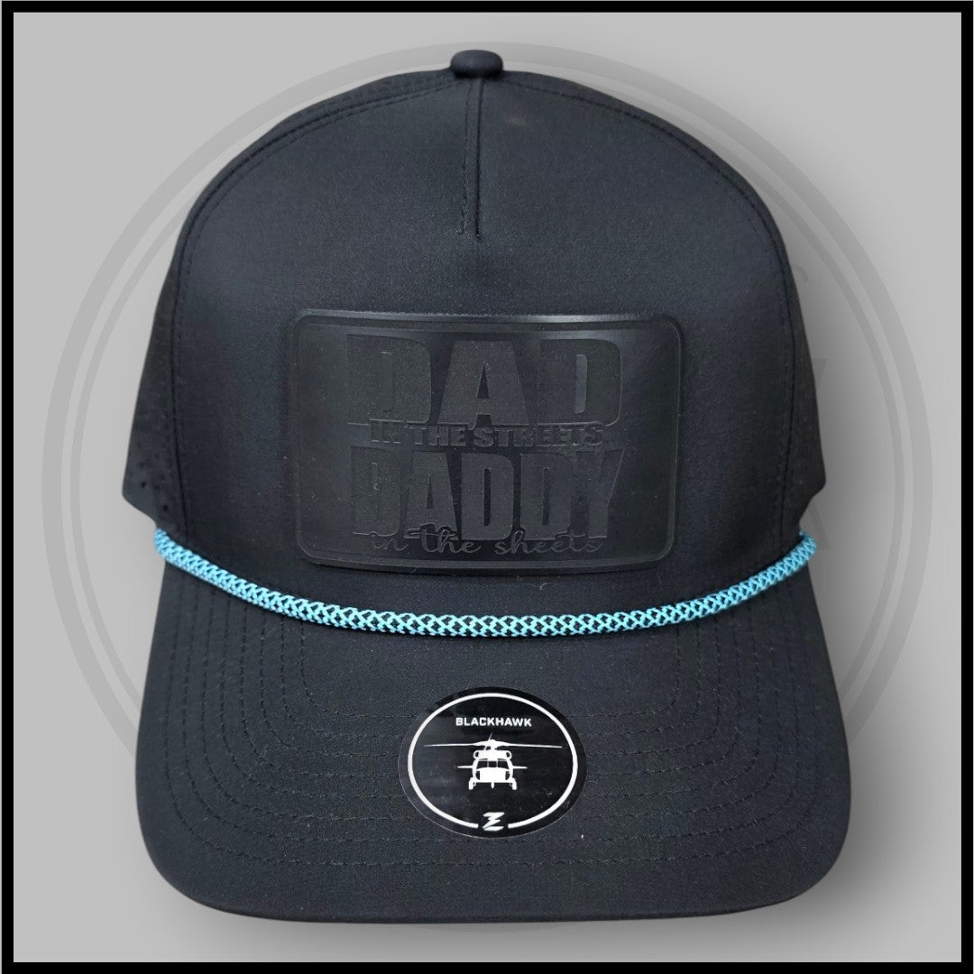 Blackhawk R+ black cap with front “DA D” patch, blue braided trim, and circular logo