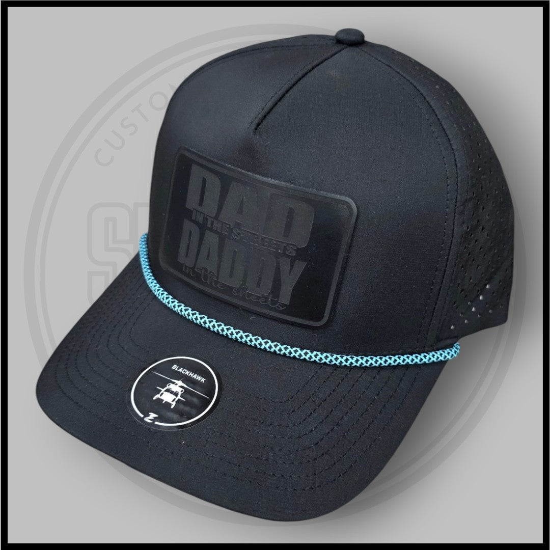 Blackhawk R+ black cap, side view with “DA D” patch and blue braided trim